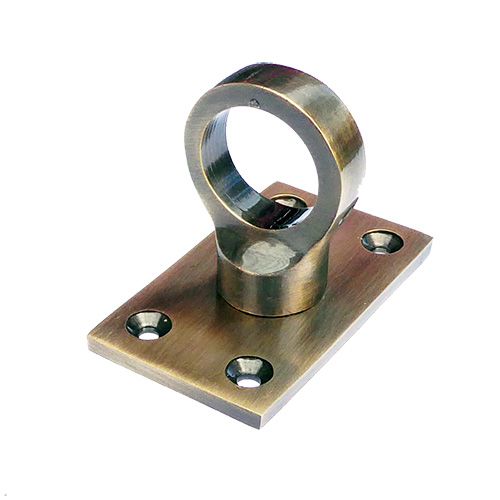Antique brass eye plate with a central circular eye for rope hooks, accompanied by four screw holes, against a plain background.