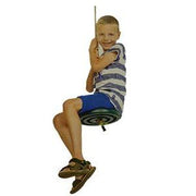 Child sitting on a plastic monkey swing against a white background