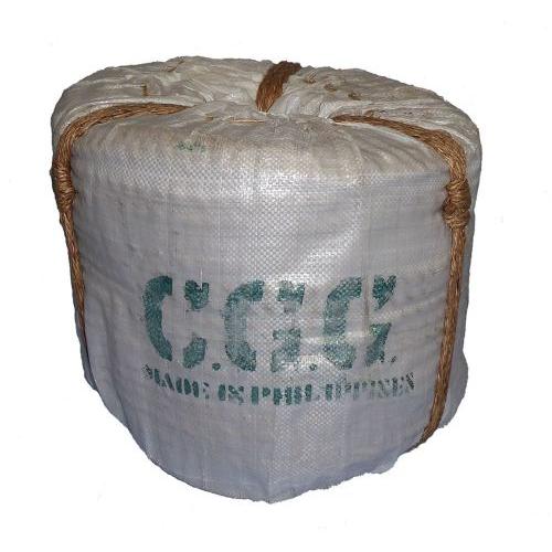 Coil of 18mm natural manila rope wrapped in white hessian and tied with brown cord.