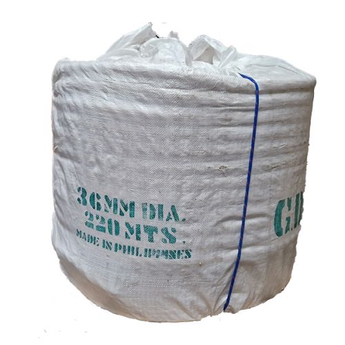 Coil of 36mm natural manila rope wrapped in white hessian and tied with blue cord.