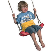 Child sitting on a red swing against a white background