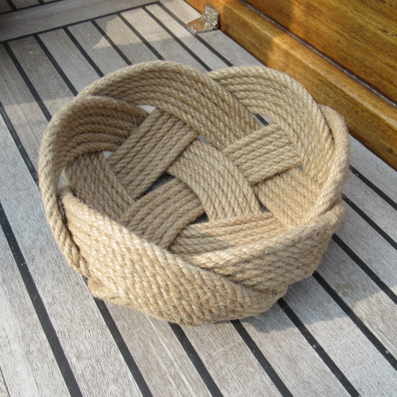 Woven 12mm jute rope basket on a wooden deck